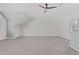 Large, carpeted bonus room with neutral walls, ceiling fan and windows for a bright, open space at 126 Maltland Dr, Cary, NC 27518