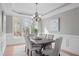 Elegant dining room featuring a rustic wood table, six upholstered chairs, and a modern chandelier at 126 Maltland Dr, Cary, NC 27518