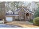 Charming two-story brick home with a well-manicured lawn and attached two-car garage at 126 Maltland Dr, Cary, NC 27518