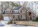 Charming two-story brick home with a well-manicured lawn and attached two-car garage at 126 Maltland Dr, Cary, NC 27518