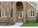 Close-up of the home's beautiful brick-arched entryway and decorative front door at 126 Maltland Dr, Cary, NC 27518