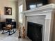 Close-up of a modern fireplace with a white mantel, gray tile surround, and a cozy seating area at 133 Sandcastle Ln, Four Oaks, NC 27524