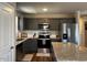 Well-appointed kitchen with gray cabinetry, stainless steel appliances, and an island with bar seating at 133 Sandcastle Ln, Four Oaks, NC 27524
