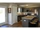 Modern kitchen with gray cabinets, stainless steel appliances, granite countertops, and a functional island at 133 Sandcastle Ln, Four Oaks, NC 27524