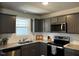Well-lit kitchen featuring granite countertops and stainless steel microwave at 133 Sandcastle Ln, Four Oaks, NC 27524