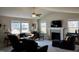 Bright living room with a fireplace, neutral color palette, and large windows offering outdoor views at 133 Sandcastle Ln, Four Oaks, NC 27524