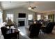 Cozy living room featuring a fireplace, comfortable seating, and ample natural light from large windows at 133 Sandcastle Ln, Four Oaks, NC 27524