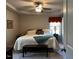 Comfortable main bedroom featuring a tray ceiling and a ceiling fan at 133 Sandcastle Ln, Four Oaks, NC 27524
