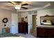 Main bedroom with tray ceiling, ceiling fan, and door to another room at 133 Sandcastle Ln, Four Oaks, NC 27524