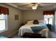 Comfortable main bedroom featuring a bed with a bedspread and two windows at 133 Sandcastle Ln, Four Oaks, NC 27524