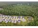 Community aerial view showcasing the neighborhood layout, surrounding trees, and a small pond at 183 Post Oak Rd, Chapel Hill, NC 27516