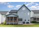 Expansive backyard featuring a screened porch, with a hot tub on the patio at 183 Post Oak Rd, Chapel Hill, NC 27516