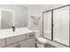 Modern bathroom featuring a glass-enclosed shower, gray vanity and contrasting black fixtures at 183 Post Oak Rd, Chapel Hill, NC 27516