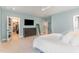 This bedroom features an ensuite bathroom, ceiling fan, large dresser and a walk-in closet for ample storage at 183 Post Oak Rd, Chapel Hill, NC 27516