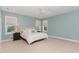 Light-filled bedroom features neutral carpet, ensuite access, large windows, ceiling fan, and dual night stands at 183 Post Oak Rd, Chapel Hill, NC 27516