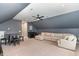 A large and inviting bonus room with a stylish wet bar, a sofa, and a game table at 183 Post Oak Rd, Chapel Hill, NC 27516