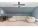 A large and inviting bonus room with a wet bar, a comfortable sectional sofa, and plush carpet at 183 Post Oak Rd, Chapel Hill, NC 27516
