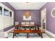 Stylish dining room features purple walls, unique light fixture, and hardwood floors at 183 Post Oak Rd, Chapel Hill, NC 27516