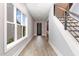 Bright entryway features a modern front door, wood-look floors, staircase and a large window providing natural light at 183 Post Oak Rd, Chapel Hill, NC 27516