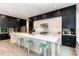 Modern kitchen featuring a large island with seating, stainless steel appliances, and black and white cabinetry at 183 Post Oak Rd, Chapel Hill, NC 27516