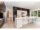 Spacious kitchen with stainless steel appliances, a large island with seating, and a view of the backyard at 183 Post Oak Rd, Chapel Hill, NC 27516