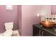 Chic powder room with modern fixtures, a vessel sink, and unique design elements at 183 Post Oak Rd, Chapel Hill, NC 27516