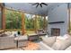 Inviting screened porch with comfortable seating, a fireplace, and views of the lush backyard at 183 Post Oak Rd, Chapel Hill, NC 27516