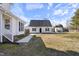 Large backyard with lawn, an outbuilding, and pathway leading to the main house at 20 Jenmar Dr, Fuquay Varina, NC 27526