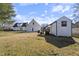 Expansive backyard with a storage shed, a small shed, and ample green space at 20 Jenmar Dr, Fuquay Varina, NC 27526