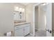 Bathroom vanity with granite countertop, white cabinets, and modern lighting fixtures at 20 Jenmar Dr, Fuquay Varina, NC 27526