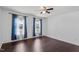 Clean bedroom featuring hardwood floors, a ceiling fan, and natural light from the two windows at 20 Jenmar Dr, Fuquay Varina, NC 27526