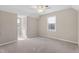 Bright bedroom featuring plush carpeting, neutral walls, and two windows providing natural light at 20 Jenmar Dr, Fuquay Varina, NC 27526