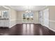 Bright dining room featuring hardwood floors, a modern chandelier, and large windows with backyard views at 20 Jenmar Dr, Fuquay Varina, NC 27526