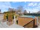 Backyard with a wooden hot tub on a deck surrounded by lush greenery and a clear sky at 20 Jenmar Dr, Fuquay Varina, NC 27526