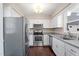 Updated kitchen featuring stainless steel appliances, granite countertops, and white cabinetry at 20 Jenmar Dr, Fuquay Varina, NC 27526