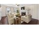 Beautifully furnished living room with fireplace, lots of seating, and natural light at 20 Jenmar Dr, Fuquay Varina, NC 27526