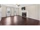 Bright living room features a fireplace, hardwood floors, and neutral paint at 20 Jenmar Dr, Fuquay Varina, NC 27526