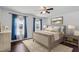 Stylized main bedroom with hardwood floors, ceiling fan, and natural light from the two windows at 20 Jenmar Dr, Fuquay Varina, NC 27526