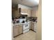Functional kitchen with white appliances, light wood cabinets, and essential cooking equipment for everyday meals at 2002 Technology Woods Drive # 103, Raleigh, NC 27603