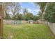 Spacious backyard featuring a shed and chicken coop surrounded by a wooden fence for privacy at 202 W Hill St, Benson, NC 27504