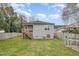 View of the backyard featuring a deck, wooden fence, and a green chicken coop at 202 W Hill St, Benson, NC 27504