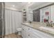 A well-designed bathroom featuring a double sink vanity with granite countertops and a modern sliding barn door at 202 W Hill St, Benson, NC 27504