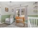A bright Bedroom room features a rocking chair and crib by a window, offering a calm and inviting space at 202 W Hill St, Benson, NC 27504
