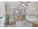 This Bedroom room showcases a cozy rocking chair and crib near a window, designed for comfort and tranquility at 202 W Hill St, Benson, NC 27504