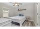 The airy bedroom features a bed, ceiling fan, natural light and creates a soothing and inviting personal space at 202 W Hill St, Benson, NC 27504