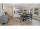 Bright dining room adjacent to the kitchen featuring modern lighting and stylish dining set at 202 W Hill St, Benson, NC 27504