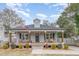 Charming home with a cozy front porch, rocking chairs, swing, and manicured landscaping at 202 W Hill St, Benson, NC 27504
