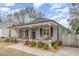 Beautiful home featuring a welcoming front porch, rocking chairs, swing, and lovely landscaping at 202 W Hill St, Benson, NC 27504