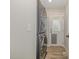 An organized laundry area showcasing a stacked washer and dryer unit, with access to the exterior of the home at 202 W Hill St, Benson, NC 27504