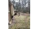 View of the backyard with a partial view of the house and the trees in the distance at 208 Essex Rd, Nashville, NC 27856